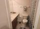 Functional bathroom with a sink, toilet, towel bar, and patterned shower curtain at 4537 Kennewick Pl # 4537, Riverview, FL 33578