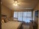 Sunlit bedroom features a wooden bed, crib and dresser providing ample space at 4537 Kennewick Pl # 4537, Riverview, FL 33578