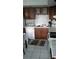 Well-lit kitchen featuring wood cabinets, white countertops, and appliances, with tile flooring at 4819 21St S Ave, St Petersburg, FL 33711