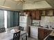 Functional kitchen with white appliances, wood cabinets, and a bright dining area near a window at 4819 21St S Ave, St Petersburg, FL 33711