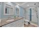 Updated bathroom featuring double sinks, granite counters, and a glass-enclosed shower at 4904 38Th S Way # 514, St Petersburg, FL 33711