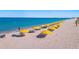 Beautiful beach scene with yellow umbrellas and beach chairs, perfect for relaxation and recreation at 4904 38Th S Way # 514, St Petersburg, FL 33711