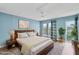 Bright bedroom with a walk-out balcony, ceiling fan, wood floors, and a serene, stylish decor at 4904 38Th S Way # 514, St Petersburg, FL 33711