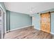 Large bedroom with wood floors and a unique barn-style door at 4904 38Th S Way # 514, St Petersburg, FL 33711