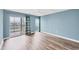 Spacious bedroom with wood floors and large glass sliding doors to the private balcony at 4904 38Th S Way # 514, St Petersburg, FL 33711