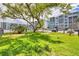 View of community dog park with grassy area and shade trees, with condo buildings in background at 4904 38Th S Way # 514, St Petersburg, FL 33711