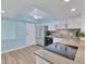 Modern kitchen with stainless steel appliances, cooktop island, and bright lighting at 4904 38Th S Way # 514, St Petersburg, FL 33711