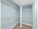 Walk-in closet featuring built-in wire shelving and laminate flooring at 4904 38Th S Way # 514, St Petersburg, FL 33711