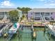 Scenic aerial view showcases waterfront condos with boat docks, lifts, and vibrant landscaping at 5260 Coquina Key Se Dr # C, St Petersburg, FL 33705
