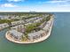 Beautiful aerial view of waterfront condos with boat docks and a glimpse of the city skyline at 5260 Coquina Key Se Dr # C, St Petersburg, FL 33705