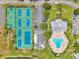 Aerial view of community tennis courts, pool, and clubhouse, showcasing recreational amenities at 5260 Coquina Key Se Dr # C, St Petersburg, FL 33705