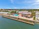 Beautiful view of building with waterfront access, a community pool, and a long pier at 5260 Coquina Key Se Dr # C, St Petersburg, FL 33705