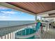 Balcony provides ocean view with seating and outdoor grill at 5260 Coquina Key Se Dr # C, St Petersburg, FL 33705