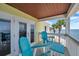 Balcony featuring outdoor seating with a view of the ocean and palm trees at 5260 Coquina Key Se Dr # C, St Petersburg, FL 33705