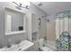 Bathroom with a sink, toilet, shower with patterned curtain, and storage cabinet at 5260 Coquina Key Se Dr # C, St Petersburg, FL 33705