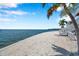 Beautiful beachfront with white stone and stairs leading up to the property at 5260 Coquina Key Se Dr # C, St Petersburg, FL 33705