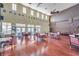 Community clubhouse with ample seating, hardwood floors, and a high ceiling at 5260 Coquina Key Se Dr # C, St Petersburg, FL 33705