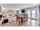 Inviting dining area with seating for six, flowing seamlessly to a deck with beautiful water views at 5260 Coquina Key Se Dr # C, St Petersburg, FL 33705