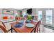 Dining area with a wooden table and seating for six, next to sliding doors to outdoor balcony at 5260 Coquina Key Se Dr # C, St Petersburg, FL 33705