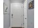 Clean and inviting entryway with a white door and neutral decor, creating a welcoming atmosphere at 5260 Coquina Key Se Dr # C, St Petersburg, FL 33705