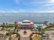 Stunning waterfront building featuring a pool, dock, and elegant architectural details with palm trees at 5260 Coquina Key Se Dr # C, St Petersburg, FL 33705