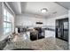 Corner kitchen featuring granite countertops, white cabinetry, and modern appliances with a pass-through to the seating area at 5260 Coquina Key Se Dr # C, St Petersburg, FL 33705