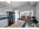 Fully equipped kitchen with a modern refrigerator and adjacent breakfast bar perfect for casual dining and food preparation at 5260 Coquina Key Se Dr # C, St Petersburg, FL 33705