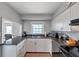 Well-equipped kitchen with white cabinets and granite countertops, offering a blend of style and practicality for cooking enthusiasts at 5260 Coquina Key Se Dr # C, St Petersburg, FL 33705