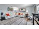 Comfortable living room with a modern sofa, stylish rug, and ample natural light at 5260 Coquina Key Se Dr # C, St Petersburg, FL 33705