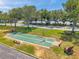 Aerial view of two shuffleboard courts with benches, picnic tables and mature trees at 5260 Coquina Key Se Dr # C, St Petersburg, FL 33705