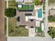 A high angle shot shows the layout of the property including the pool, driveway, and fenced backyard at 5401 3Rd N Ave, St Petersburg, FL 33710