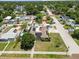 This aerial shot displays a home with solar panels, a pool, playground, and boat, nestled in a friendly neighborhood at 5401 3Rd N Ave, St Petersburg, FL 33710
