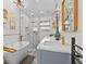 Bathroom with marble countertops, tile floors, walk-in shower, and free-standing tub at 5401 3Rd N Ave, St Petersburg, FL 33710