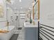 Bathroom with double sinks, marble countertops, tile floors, walk-in shower, and free-standing tub at 5401 3Rd N Ave, St Petersburg, FL 33710