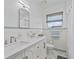 Bright bathroom featuring a double sink vanity, tiled walls, and modern fixtures at 5401 3Rd N Ave, St Petersburg, FL 33710