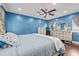 Bedroom with blue walls, wood floors, ceiling fan, and dresser at 5401 3Rd N Ave, St Petersburg, FL 33710
