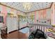 Bedroom features pink walls with polka dots on ceiling, hardwood floors, and light-colored furniture set at 5401 3Rd N Ave, St Petersburg, FL 33710