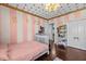Charming bedroom with hardwood floors, white closet doors, and lots of natural light at 5401 3Rd N Ave, St Petersburg, FL 33710