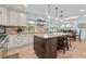Open kitchen with stone backsplash, large island, granite countertops, stainless appliances, and a dining nook at 5401 3Rd N Ave, St Petersburg, FL 33710