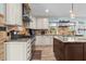 Kitchen with stainless appliances, wood flooring, stone backsplash, granite countertops, and a large island at 5401 3Rd N Ave, St Petersburg, FL 33710