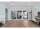 Spacious living room featuring wood-look floors, recessed lights, and a sliding glass door at 5401 3Rd N Ave, St Petersburg, FL 33710