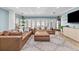 Bright living room featuring a comfortable sectional sofa, wood floors, and a large television at 5401 3Rd N Ave, St Petersburg, FL 33710