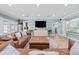 Stylish living room featuring a large sectional sofa, a modern TV console, and plenty of natural light at 5401 3Rd N Ave, St Petersburg, FL 33710