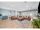Bright and spacious living room with wood floors, a comfortable sectional, and access to the outdoor patio at 5401 3Rd N Ave, St Petersburg, FL 33710