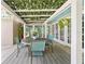 Relaxing outdoor space featuring a dining table, string lights, and a ceiling covered with foliage at 5401 3Rd N Ave, St Petersburg, FL 33710