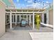 Cozy patio with dining area under a pergola adorned with climbing plants and string lights at 5401 3Rd N Ave, St Petersburg, FL 33710