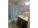 Cozy bathroom with vanity, toilet, and shower/tub featuring blue shower curtain at 5705 80Th N St # 303, St Petersburg, FL 33709