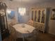 Elegant dining room with a chandelier, china cabinet, and seating for four, perfect for formal meals at 5705 80Th N St # 303, St Petersburg, FL 33709