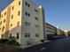 Well-maintained exterior of a condominium complex with ample parking and manicured landscaping at 5705 80Th N St # 303, St Petersburg, FL 33709