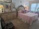 Ornate main bedroom with pink bedding, classic furnishings, and bright natural light at 5705 80Th N St # 303, St Petersburg, FL 33709